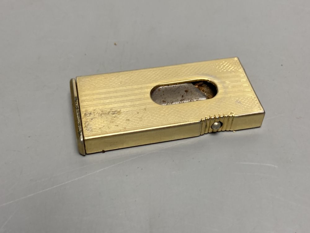 A gold plated Dunhill lighter no. A50077 and a German Dominus cigar cutter